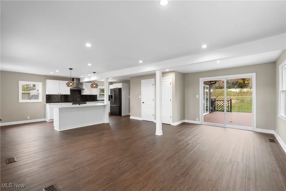 Unfurnished living room with dark wood finished floors and recessed lighting