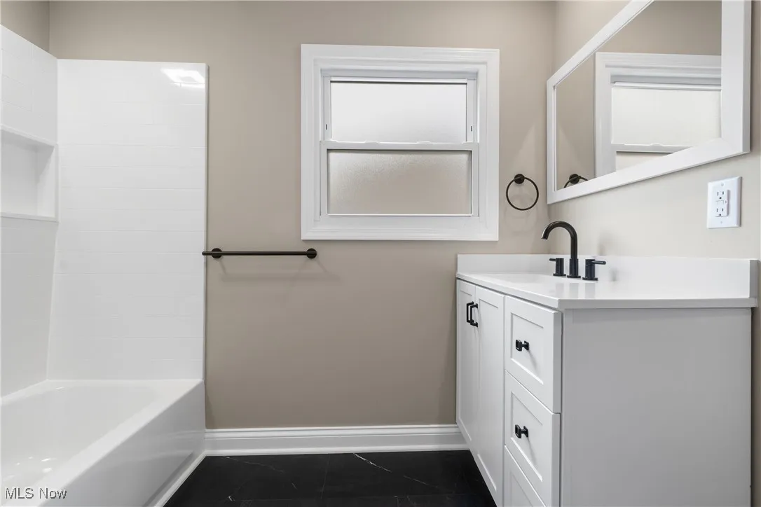 Bathroom with vanity and  shower combination