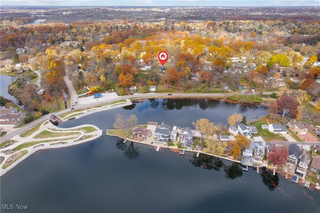 Aerial view of property and surrounding area with a nearby body of water