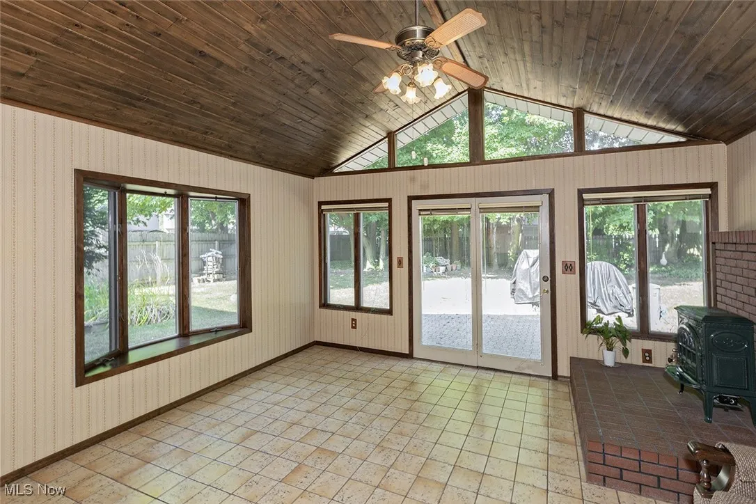 Unfurnished sunroom with vaulted ceiling
