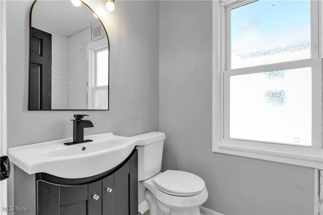 Half bath featuring vanity and toilet