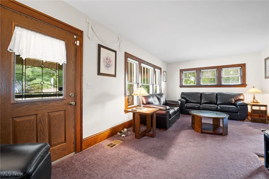 Living area with carpet and baseboards