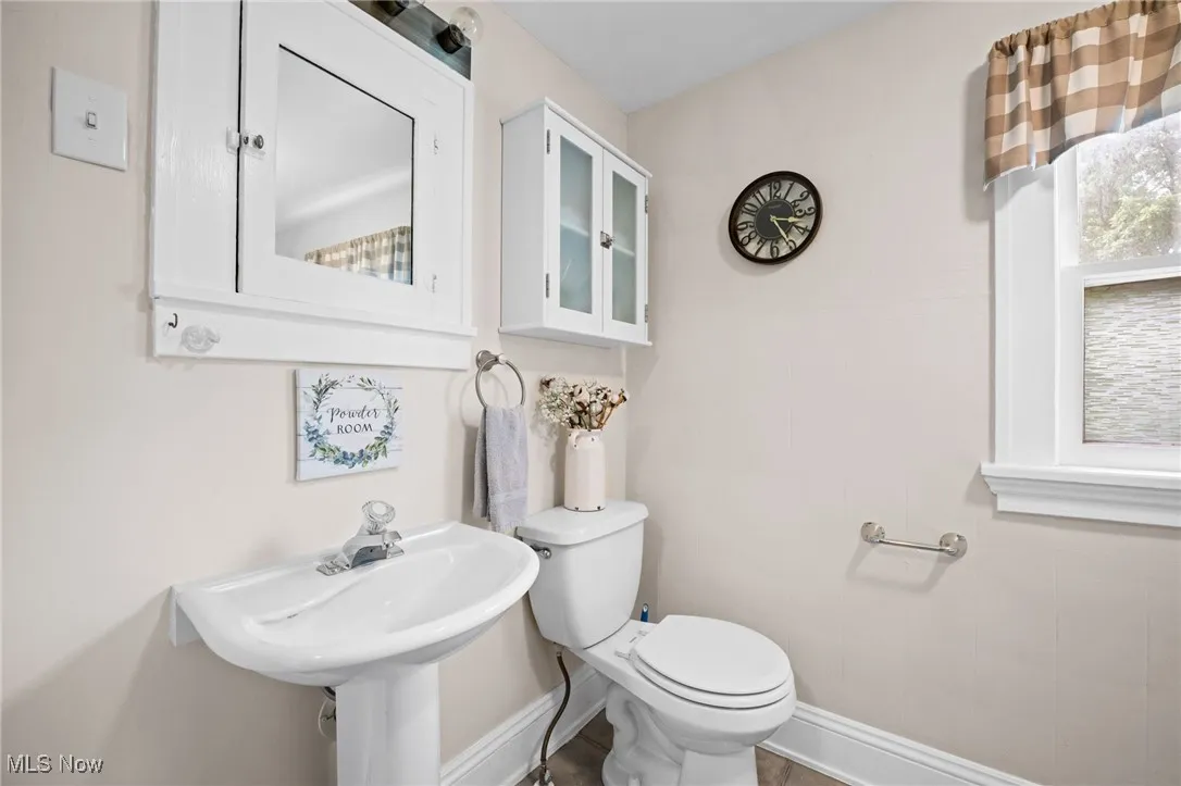 Bathroom featuring toilet and baseboards