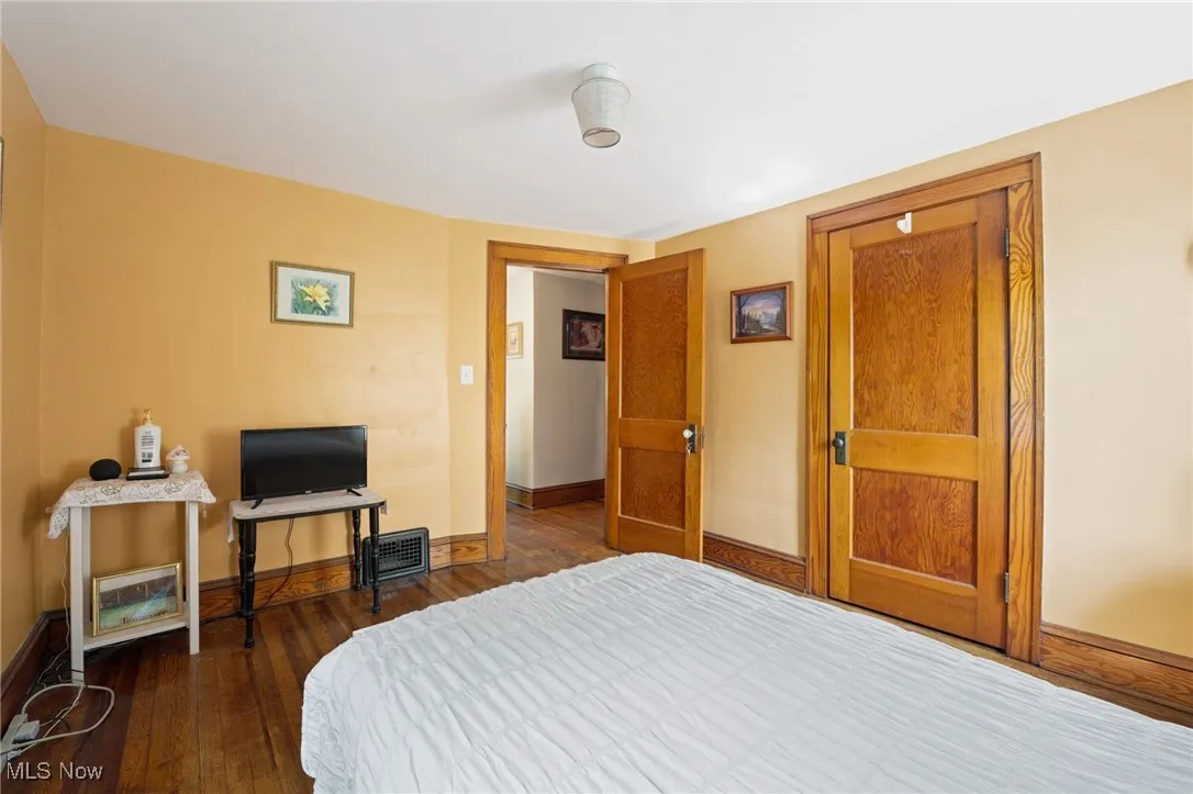 Bedroom with wood-type flooring and baseboards