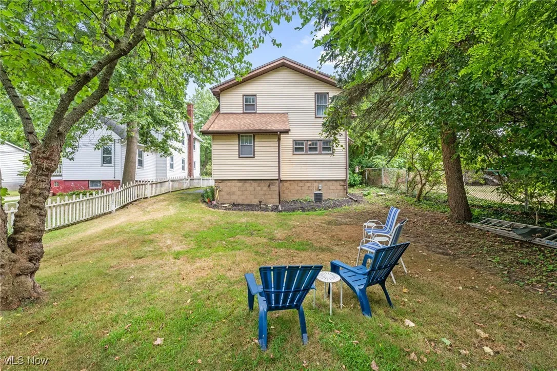Rear view of house featuring a fenced backyard