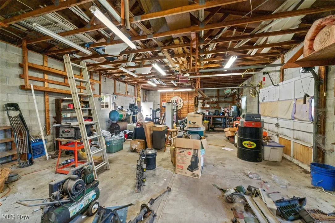 Garage with concrete block wall and a workshop area