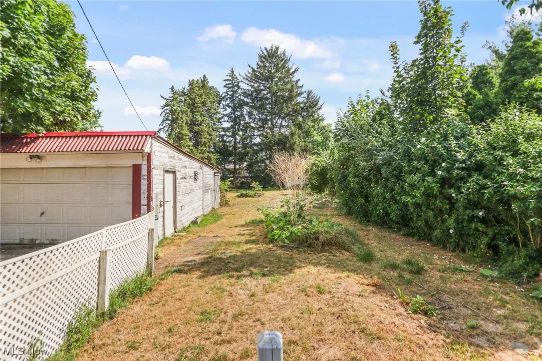 View of yard featuring an outbuilding and a detached garage