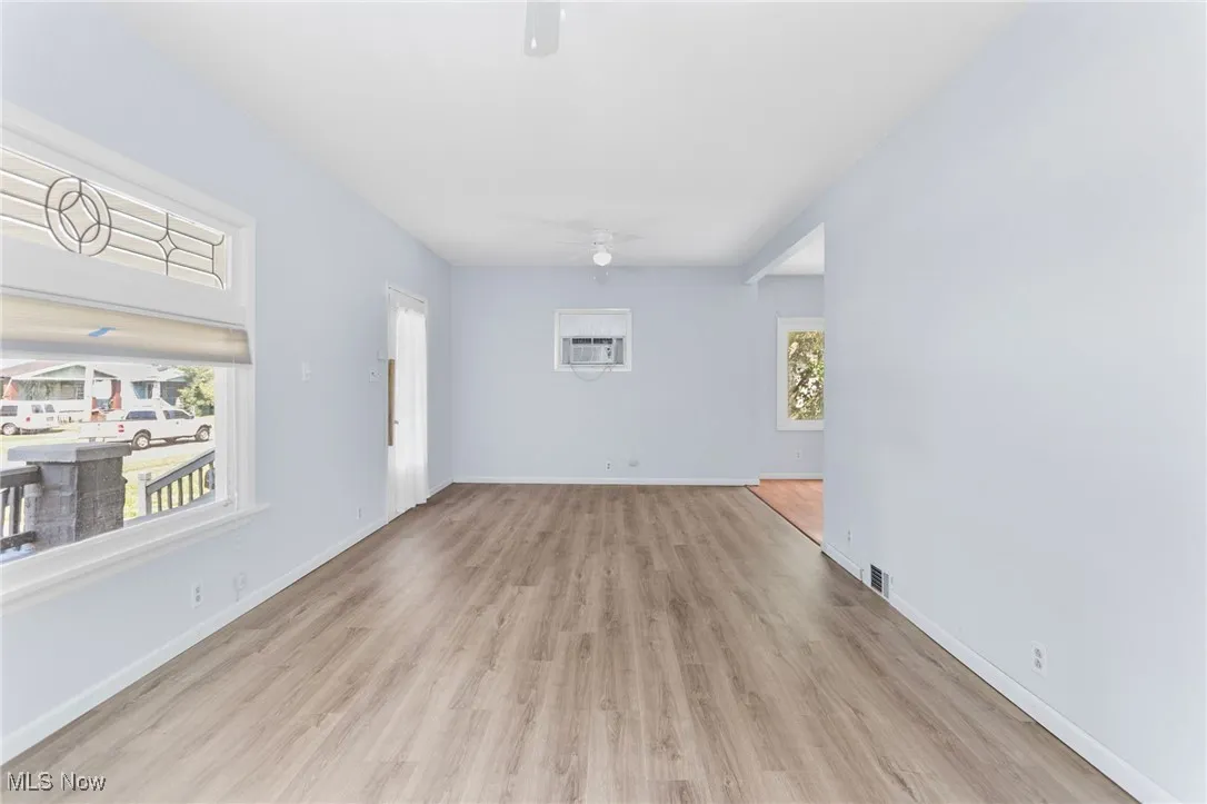 Empty room with a ceiling fan and wood finished floors