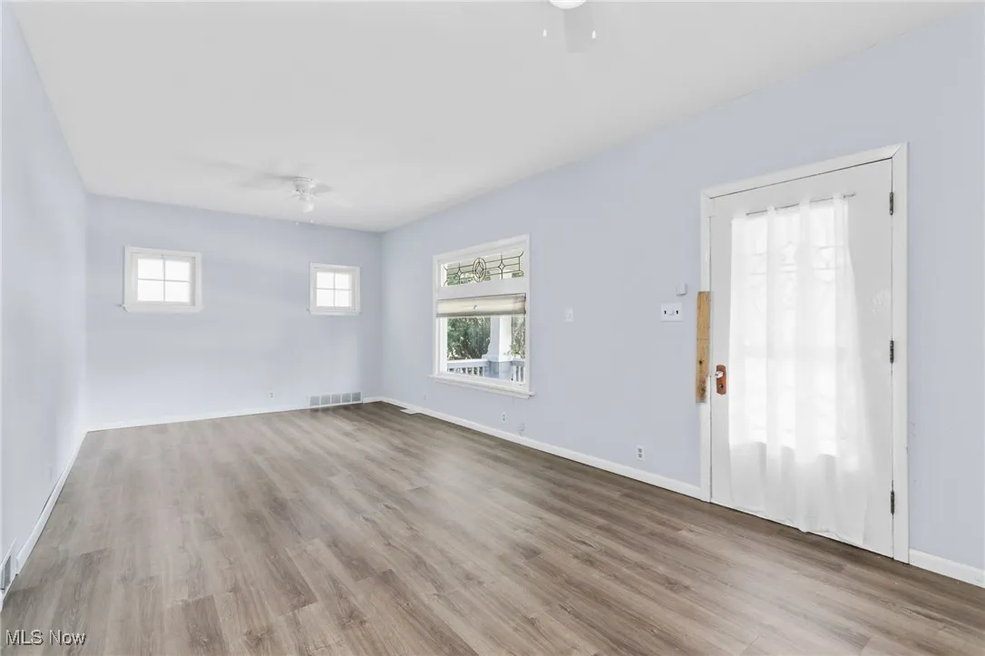 Empty room featuring a ceiling fan and wood finished floors