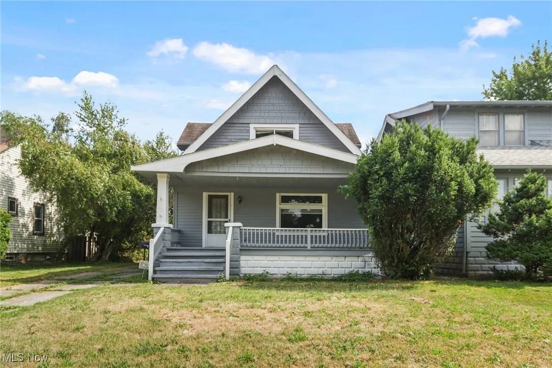 View of front of home featuring covered porch and a front lawn