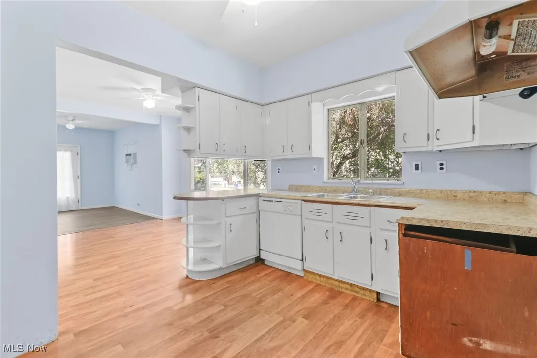 Kitchen featuring open shelves, a ceiling fan, and white cabinets