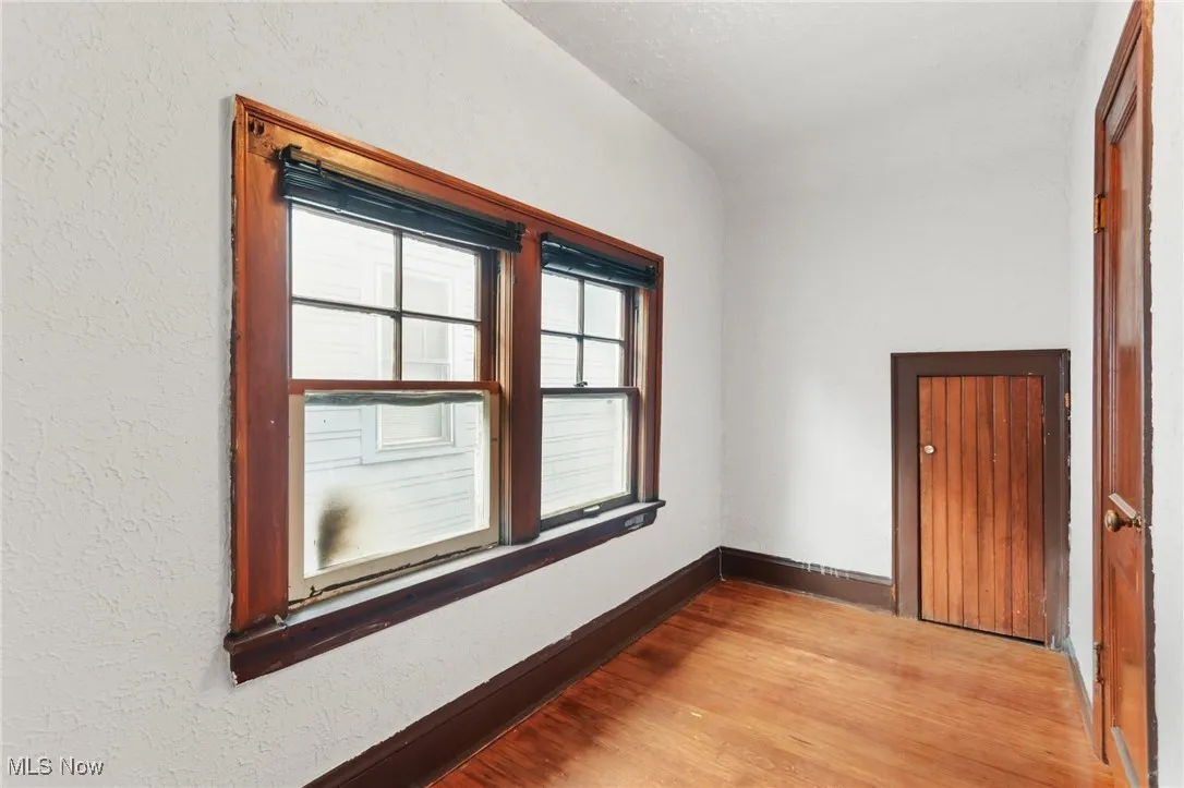 Empty room with wood finished floors and baseboards