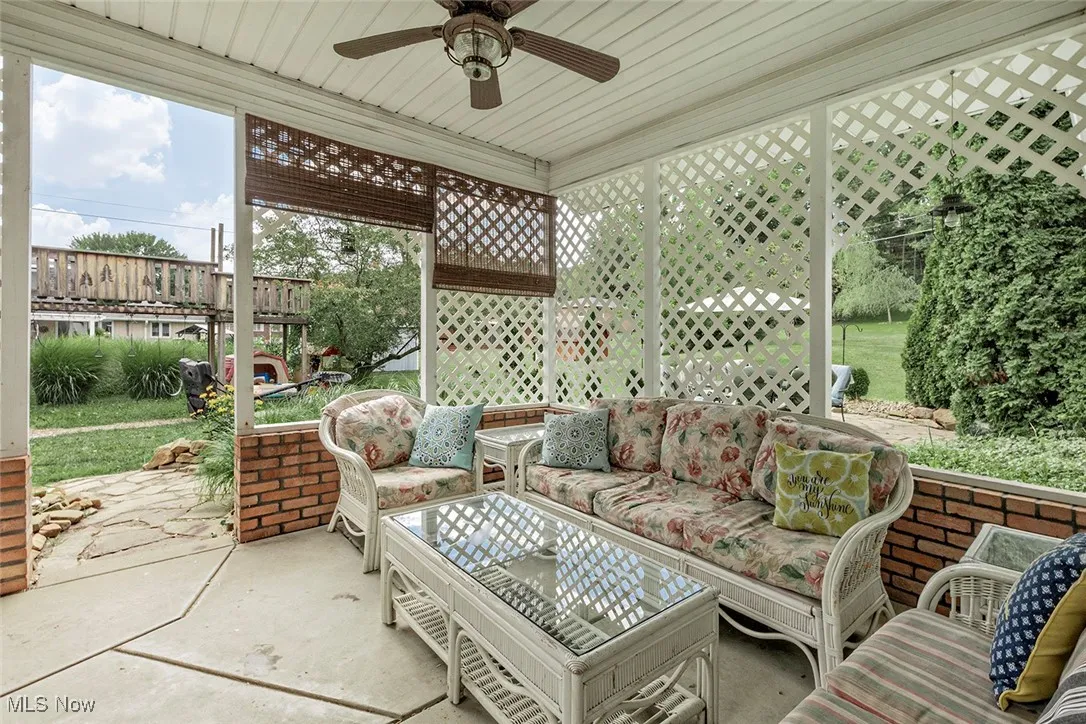 Sunroom / solarium featuring a ceiling fan and an outdoor hangout area