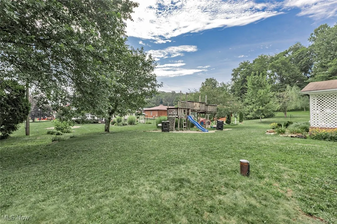 View of grassy yard with a playground