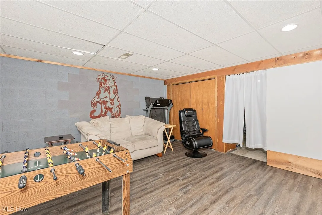 Game room featuring a paneled ceiling, recessed lighting, and wood finished floors