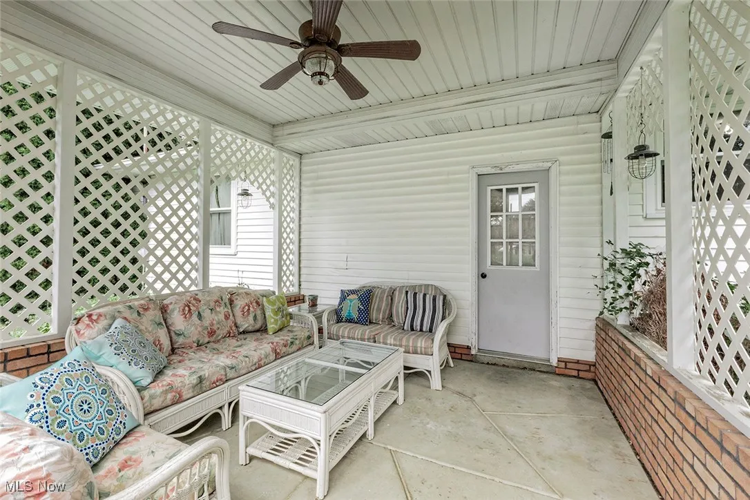 Sunroom with an outdoor living space and a ceiling fan
