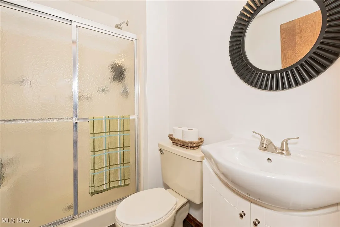 Full bath featuring a stall shower and vanity
