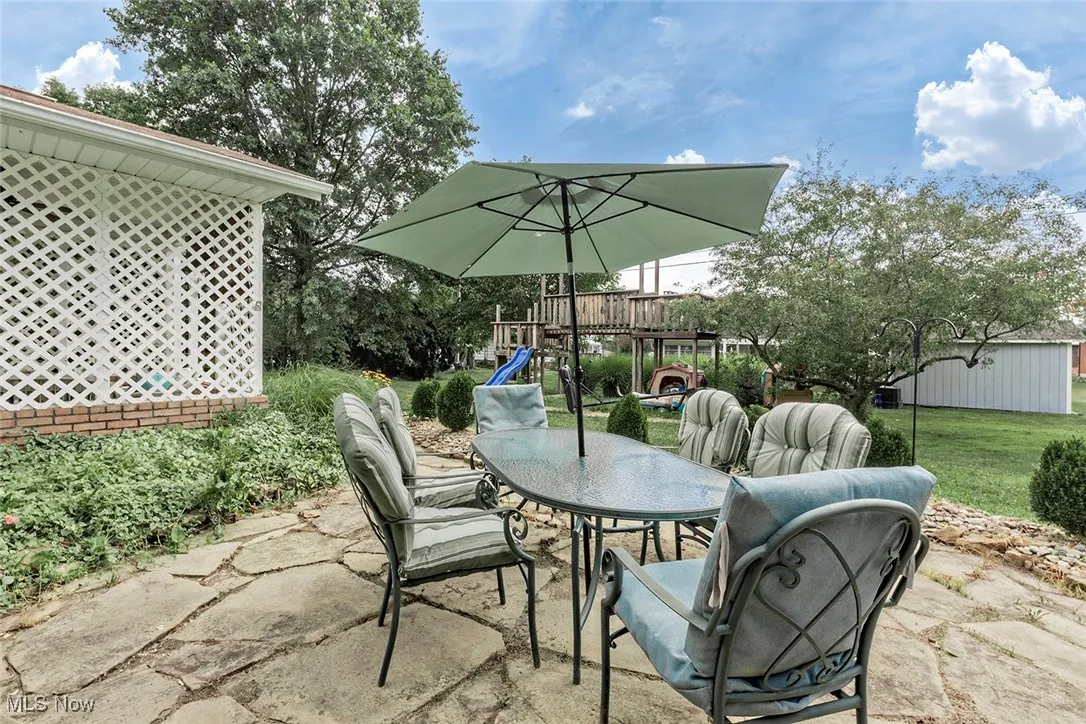 View of patio / terrace featuring a playground and outdoor dining area