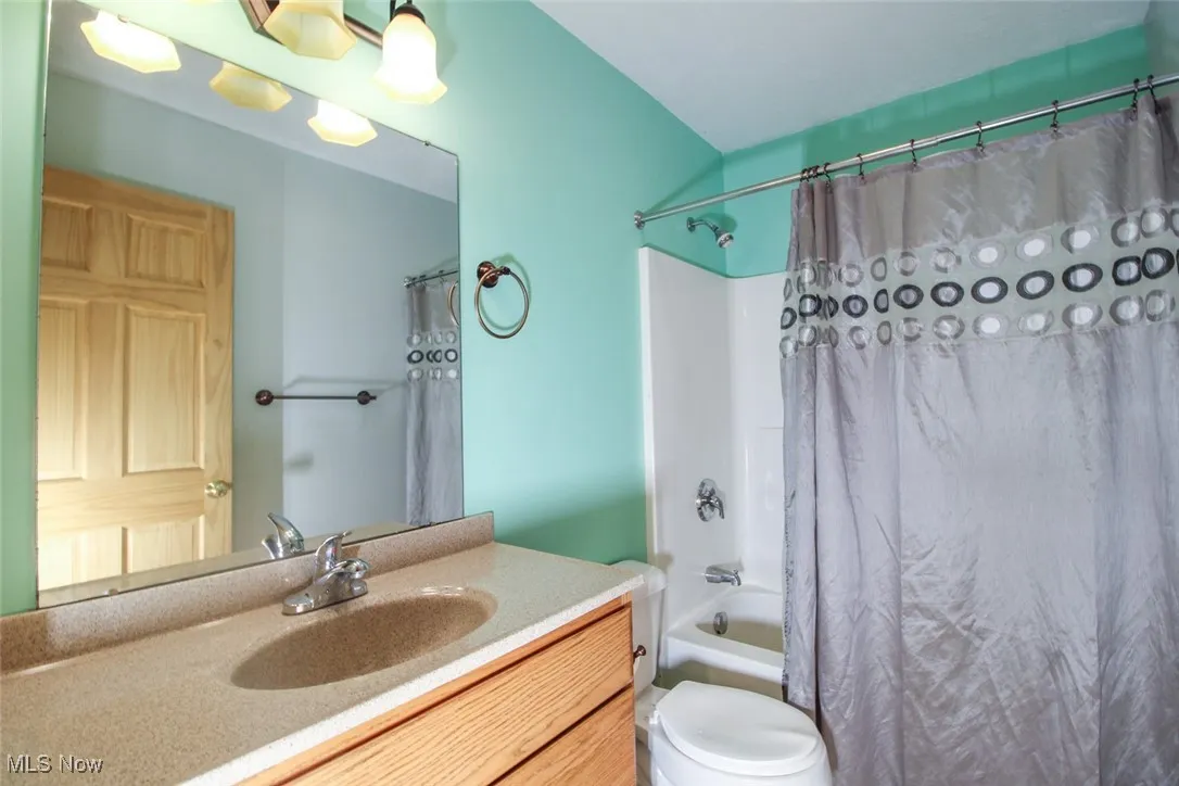 Full bathroom with vanity and shower / tub combo
