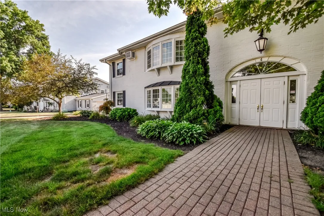 View of exterior entry with a lawn
