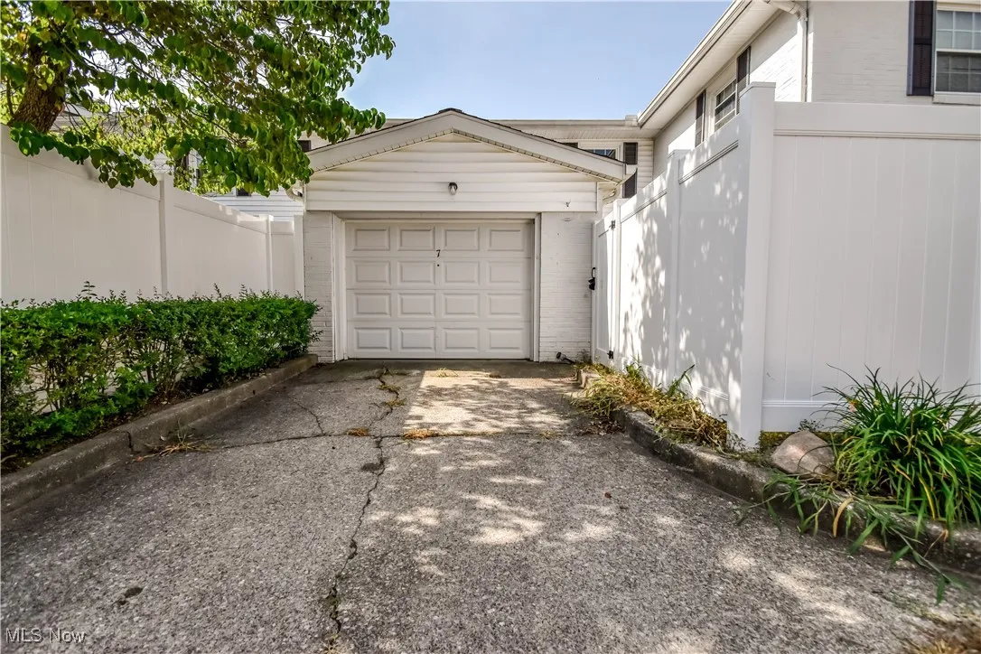 Garage featuring concrete driveway