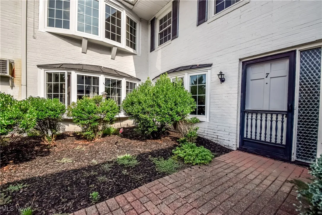 Entrance to property with brick siding
