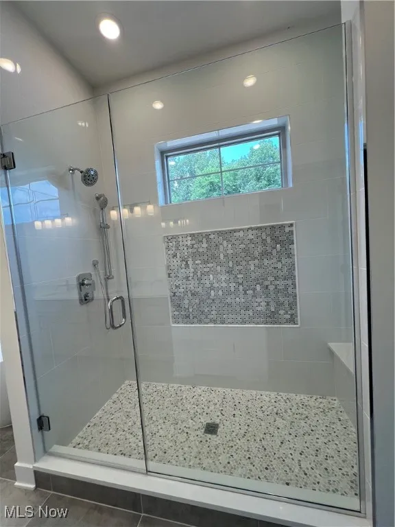 Full bathroom with a stall shower, tile patterned floors, and recessed lighting