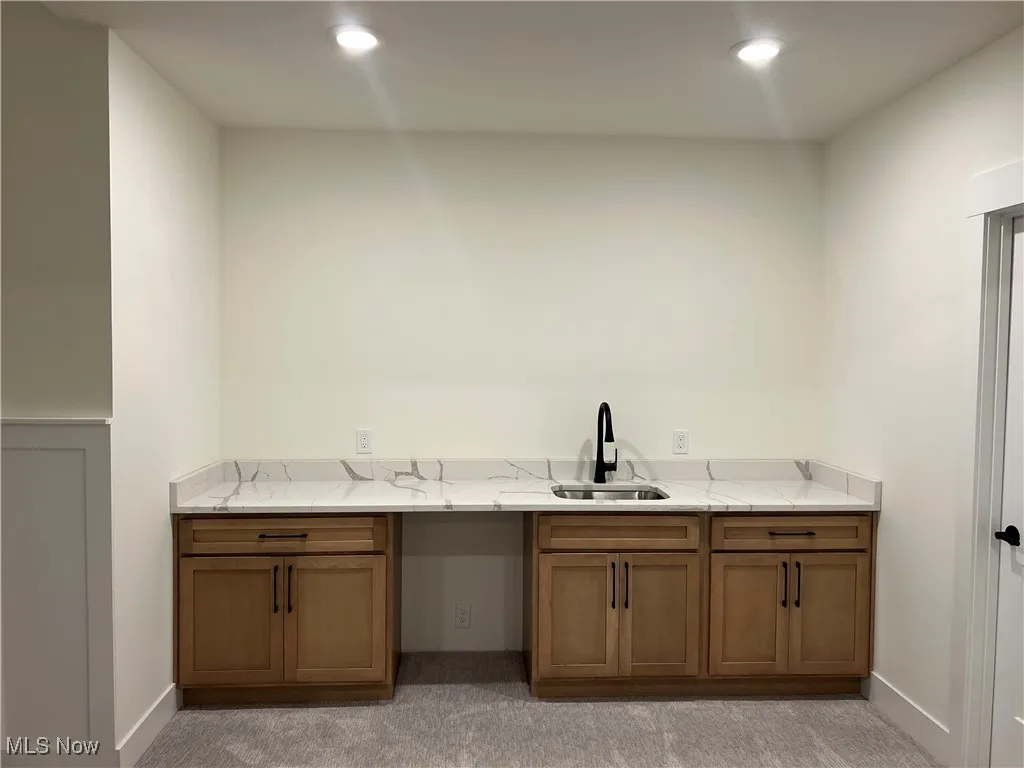 Bar area with recessed lighting and light carpet