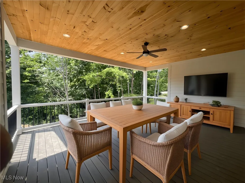 Deck featuring outdoor dining space and a ceiling fan