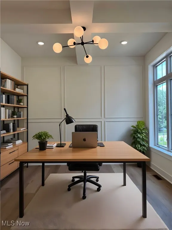 Office space featuring a decorative wall, dark wood-style flooring, recessed lighting, and a chandelier