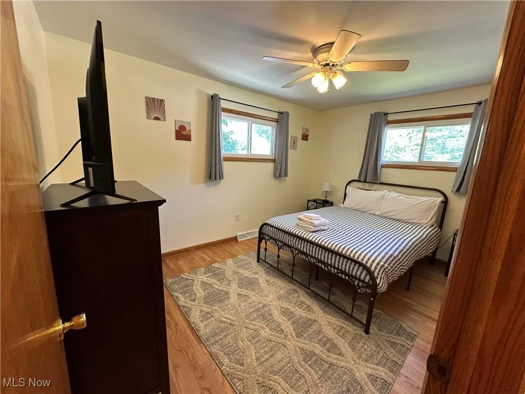 Bedroom featuring hardwood floors and a ceiling fan