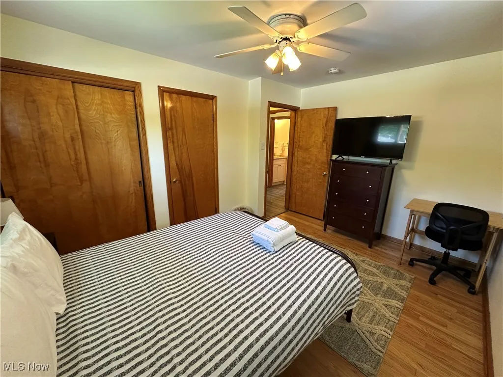 Bedroom featuring hardwood floors and a ceiling fan