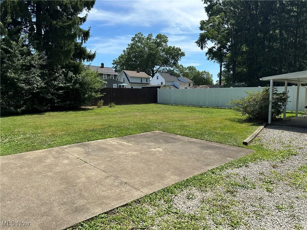Fenced backyard with a patio