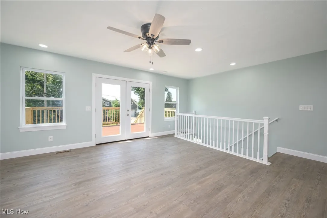Living room with recessed lighting, wood finished floors, a ceiling fan, and french doors