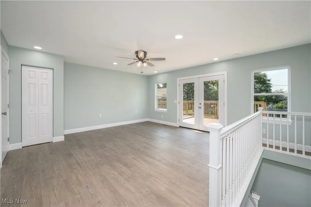 Living room, recessed lighting, a ceiling fan, and french doors