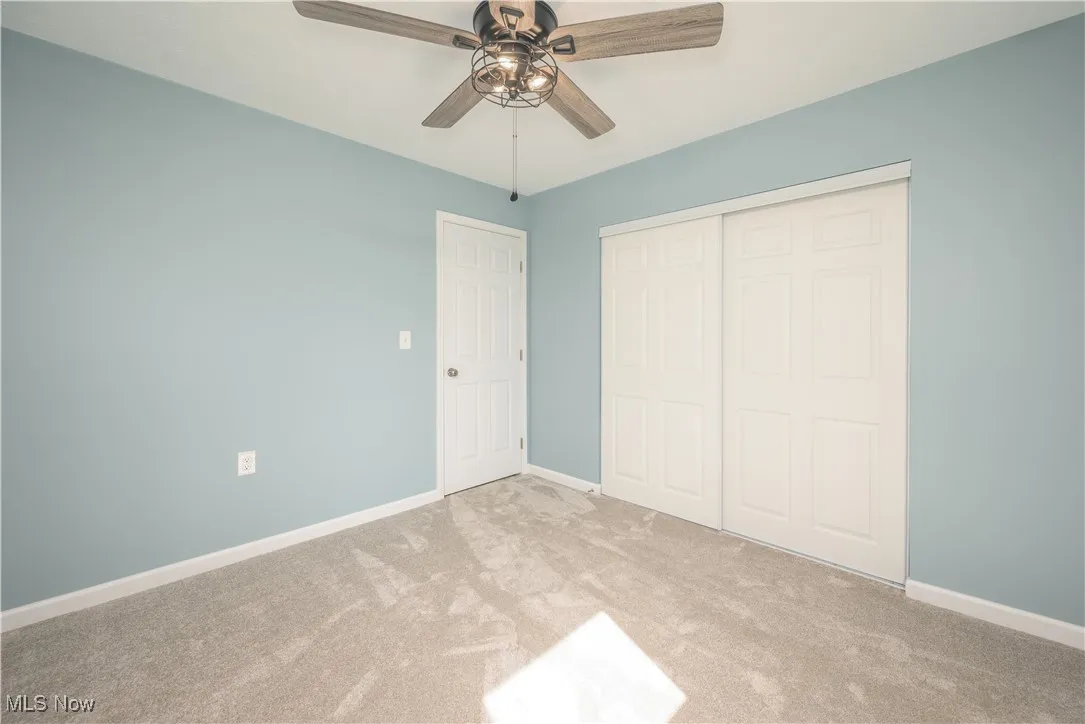 bedroom featuring carpet floors, a closet, and ceiling fan