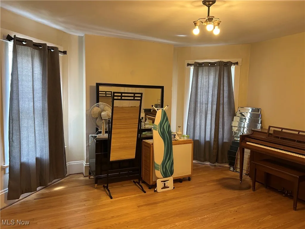 Bedroom featuring light wood-style flooring and a chandelier