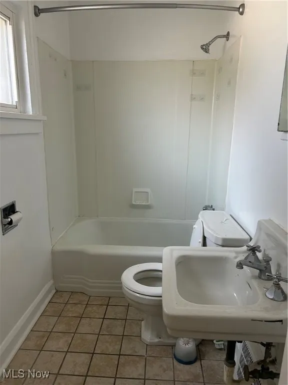 Bathroom featuring tile patterned floors and shower / bath combination