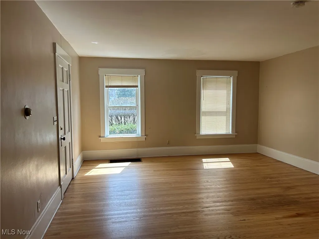 Empty room featuring wood finished floors