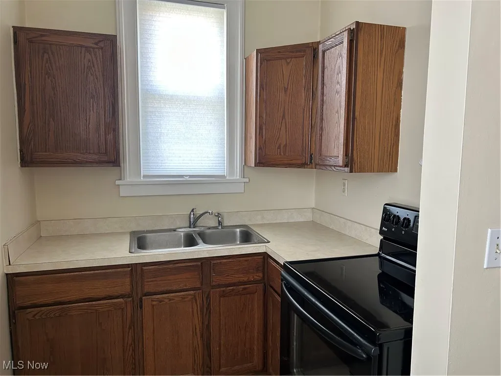 Kitchen with range and light countertops