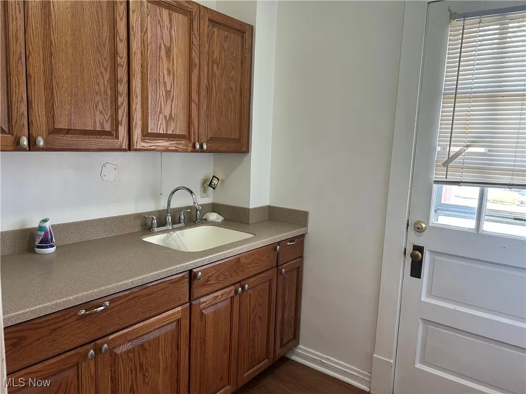 Kitchen with brown cabinets and dark wood finished floors