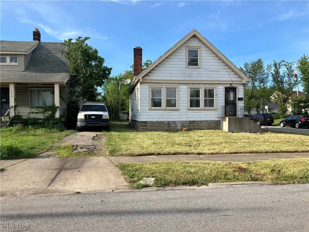 View of front of home featuring a front lawn and a chimney