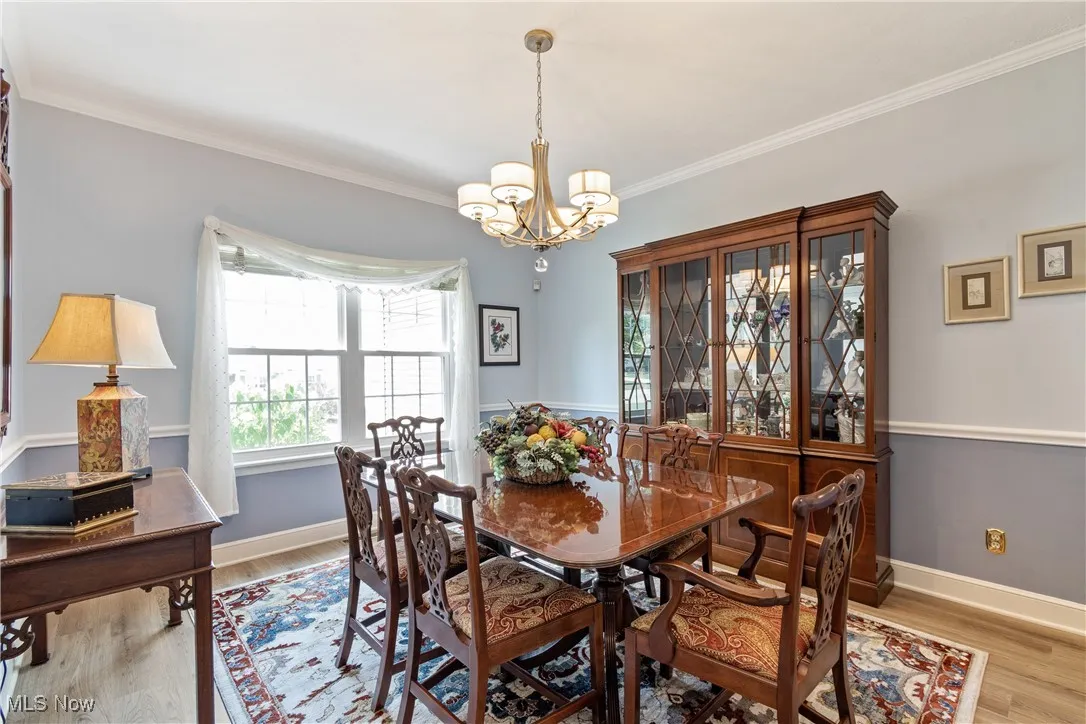 Dining room with crown molding and chir rail