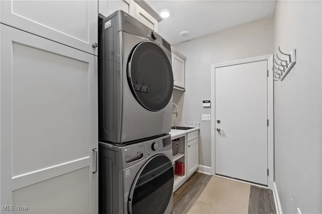 Main level laundry w/ stainless sink and broom closet