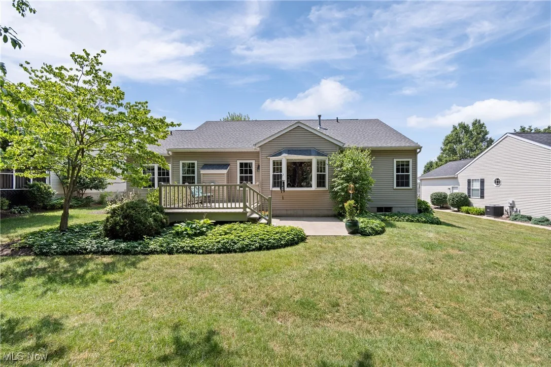 Rear of home with deck and patio