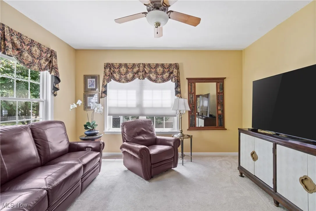 Den with carpeting and french doors
