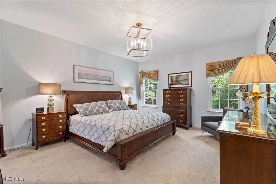 Primary bedroom with carpeting