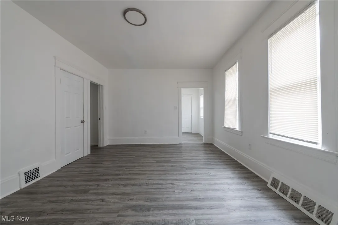 Spare room with dark wood-style floors