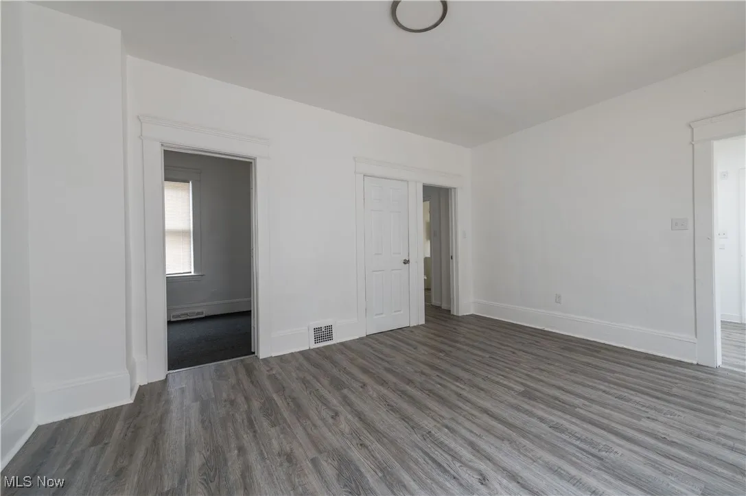 Empty room with wood finished floors and baseboards