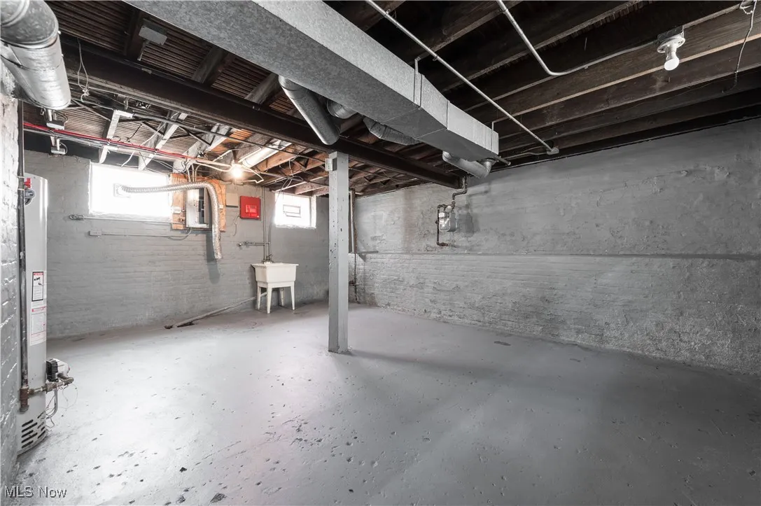 Below grade area featuring water heater